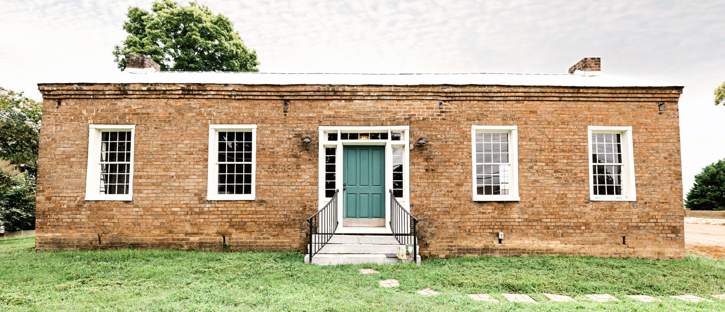 Exterior shot of the Drawing Room with green door and four large windows